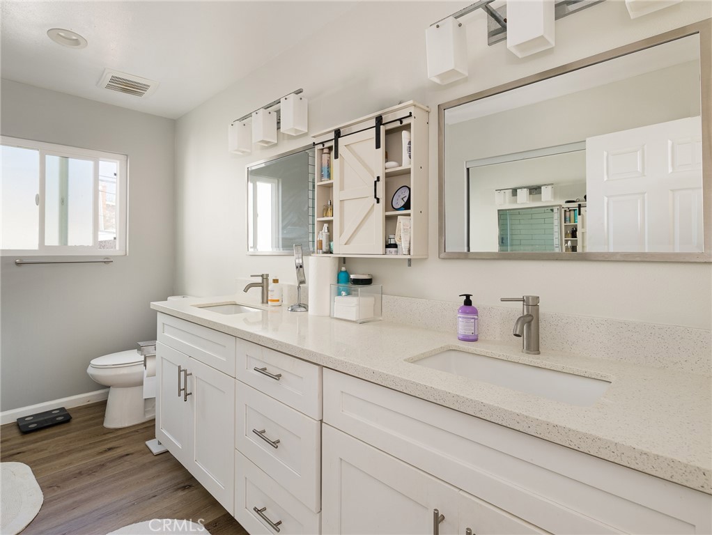526 Sheldon Street El Segundo, CA 90245 - Photo 33 of 41 a bathroom with a double vanity sink toilet and mirror