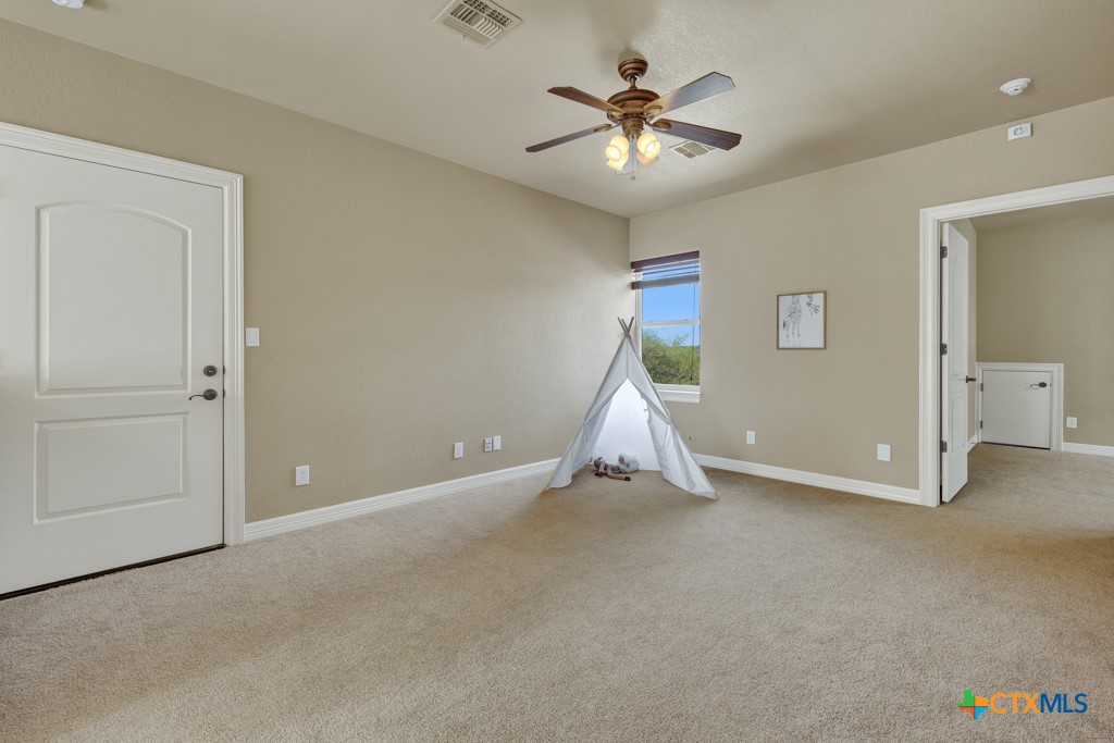 7607 Sky Loop Garden Ridge, TX 78266 - Photo 30 of 43 an empty room with closet and windows