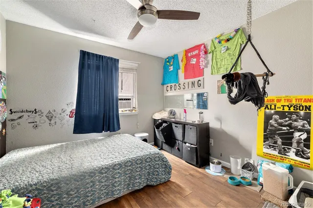 a bedroom with a bed and a dresser in it