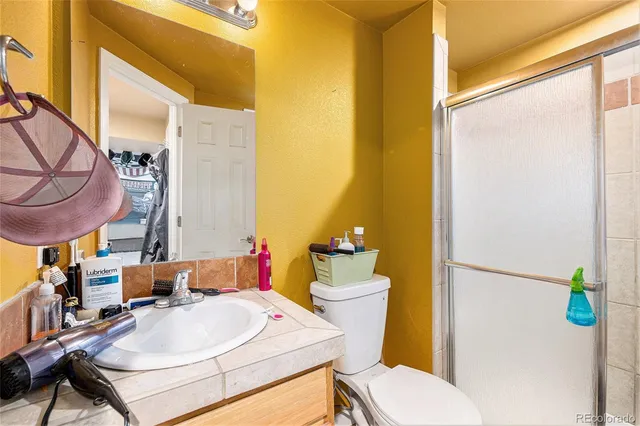 a bathroom with a sink mirror vanity and toilet