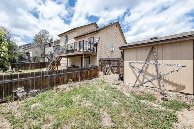 a view of a house with wooden fence