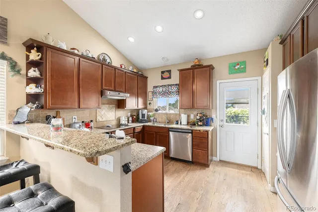 a kitchen with a sink stove and refrigerator