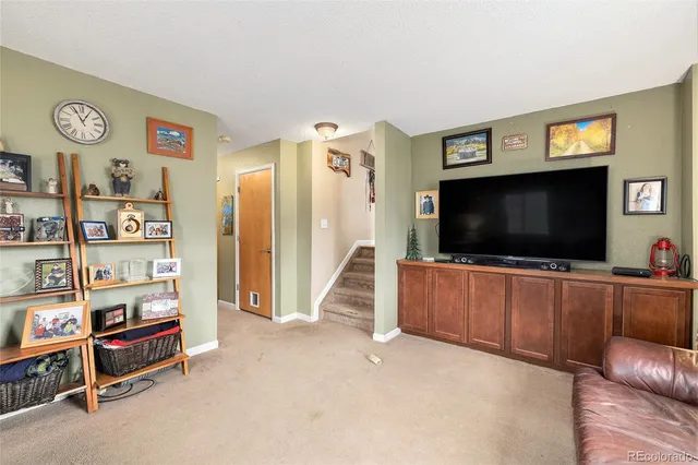 a view of a livingroom with furniture and a flat screen tv