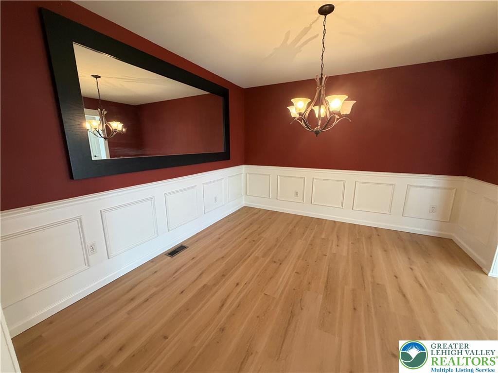 4157 Walter Road Bethlehem, PA 18020 - Photo 13 of 36 Elegant wainscoting and a distinctive chandelier define this inviting dining space.