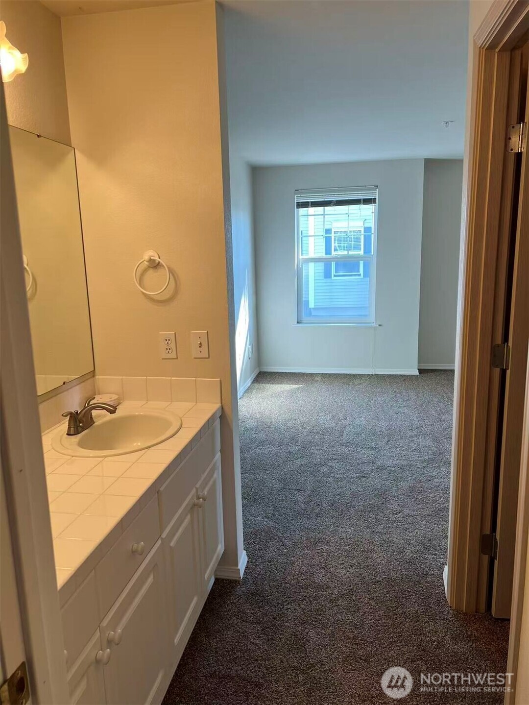 1160 Monroe Avenue Northeast, Unit D3 Renton, WA 98056 - Photo 11 of 15 a bathroom with a granite countertop sink a mirror and a bathtub