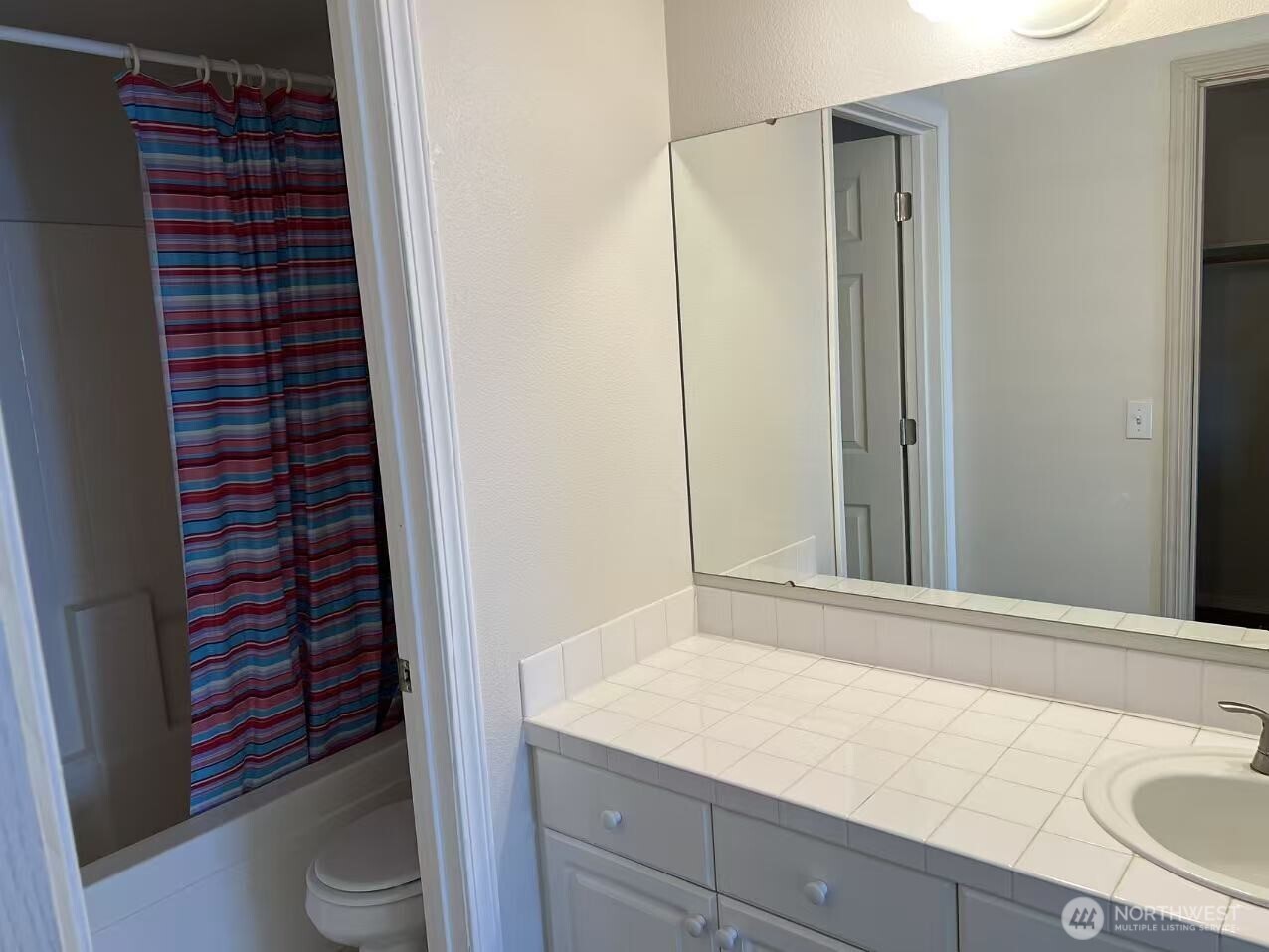 1160 Monroe Avenue Northeast, Unit D3 Renton, WA 98056 - Photo 9 of 15 a bathroom with a granite countertop sink a toilet and shower