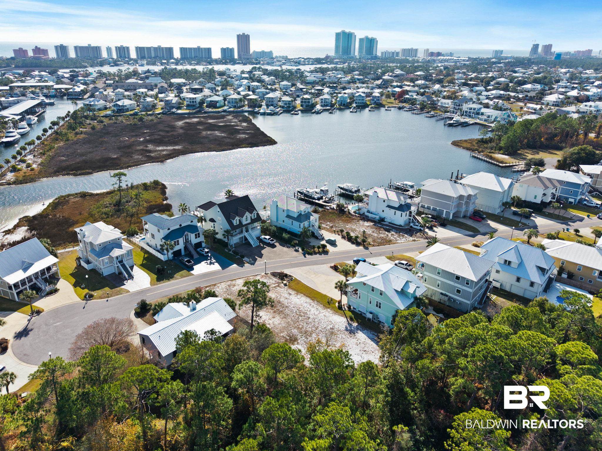 4143 Harbor Road Orange Beach, AL 36561 - Photo 18 of 33 Aerial perspective of suburban area with a nearby body of water and skyline