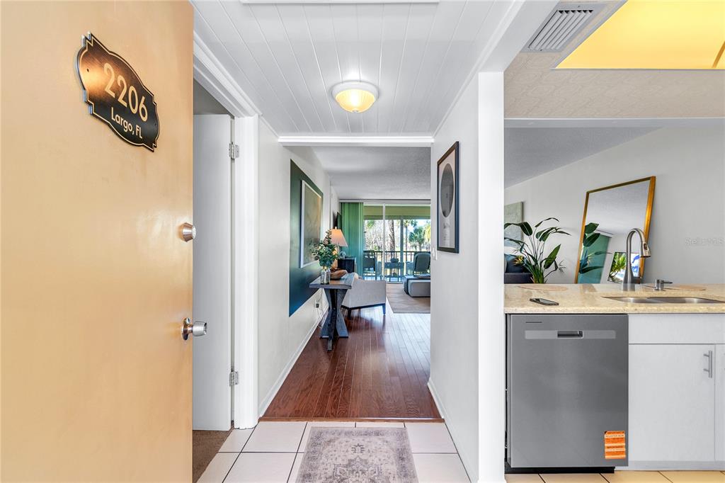 12200 Vonn Road, Unit 2206 Largo, FL 33774 - Photo 6 of 60 a view of a hallway view with wooden floor and a living room