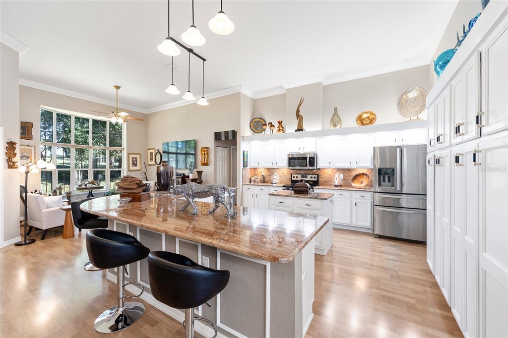 11615 Southwest 72nd Circle Ocala, FL 34476 - Photo 13 of 51 a kitchen with stainless steel appliances granite countertop a sink stove and refrigerator