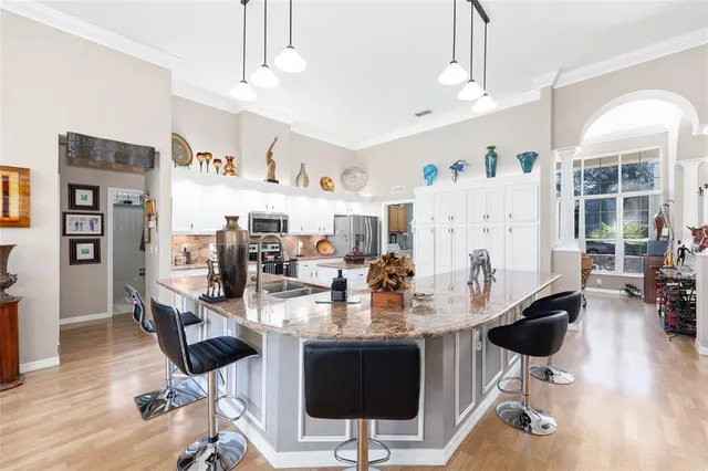 a kitchen with stainless steel appliances granite countertop a stove and cabinets