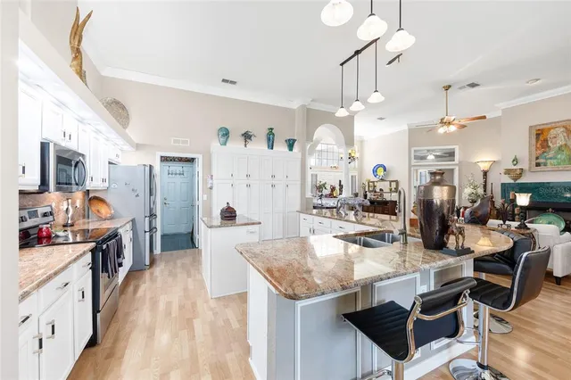 a kitchen with stainless steel appliances kitchen island granite countertop lots of counter top space