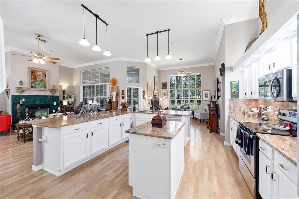 11615 Southwest 72nd Circle Ocala, FL 34476 - Photo 17 of 51 a kitchen with stainless steel appliances kitchen island granite countertop lots of counter top space