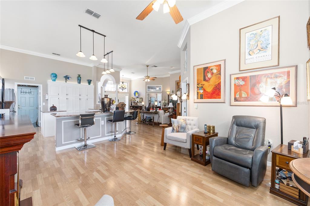 11615 Southwest 72nd Circle Ocala, FL 34476 - Photo 20 of 51 a living room with furniture and a chandelier