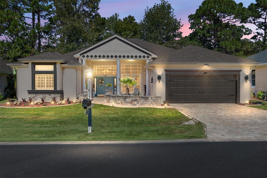 11615 Southwest 72nd Circle Ocala, FL 34476 - Photo 2 of 51 a front view of a house with garden