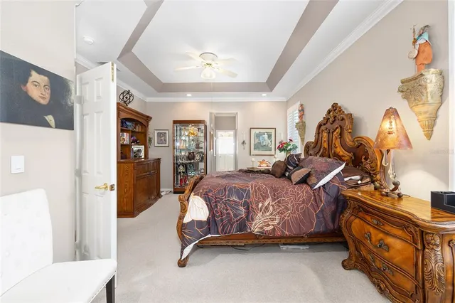 a bed room with a bed mirror and a chandelier