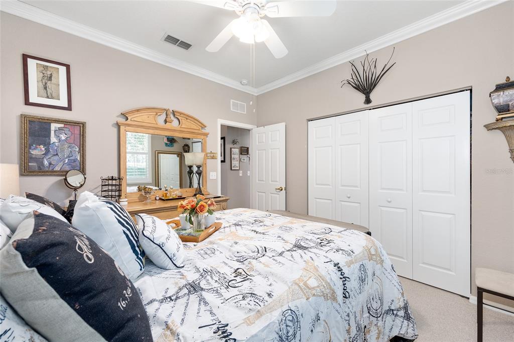 11615 Southwest 72nd Circle Ocala, FL 34476 - Photo 38 of 51 a bedroom with a bed and a large mirror