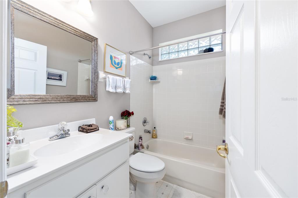 11615 Southwest 72nd Circle Ocala, FL 34476 - Photo 39 of 51 a bathroom with a sink a toilet and shower curtain