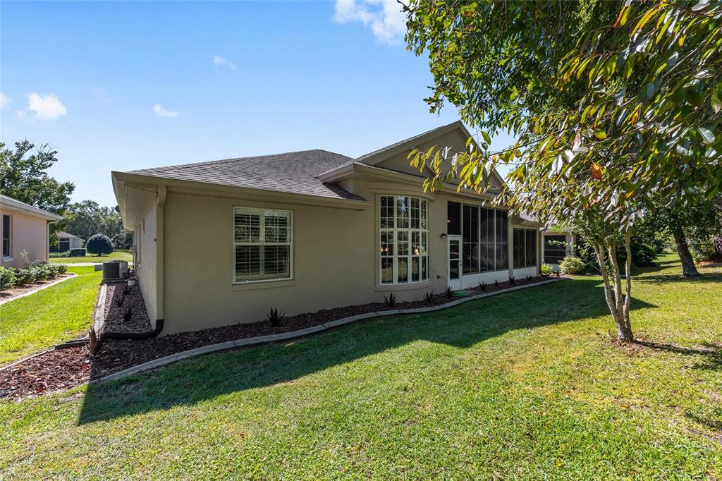 11615 Southwest 72nd Circle Ocala, FL 34476 - Photo 44 of 51 a view of a house with a yard and a garden