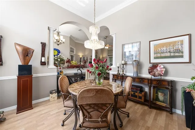 a living room with patio furniture and a chandelier