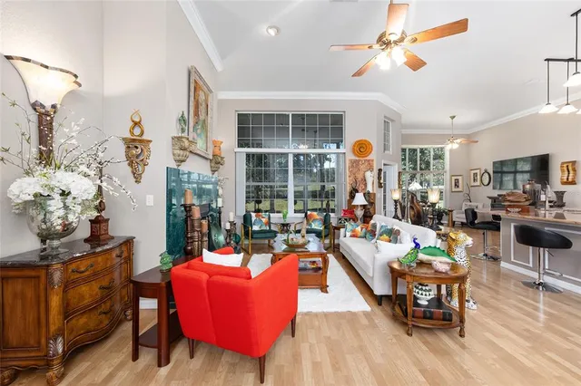 a living room filled with furniture and a chandelier