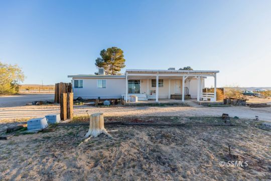 1221 Nocturne Street Ridgecrest, CA 93555 - Photo 4 of 32 a view of a house with backyard and a chair