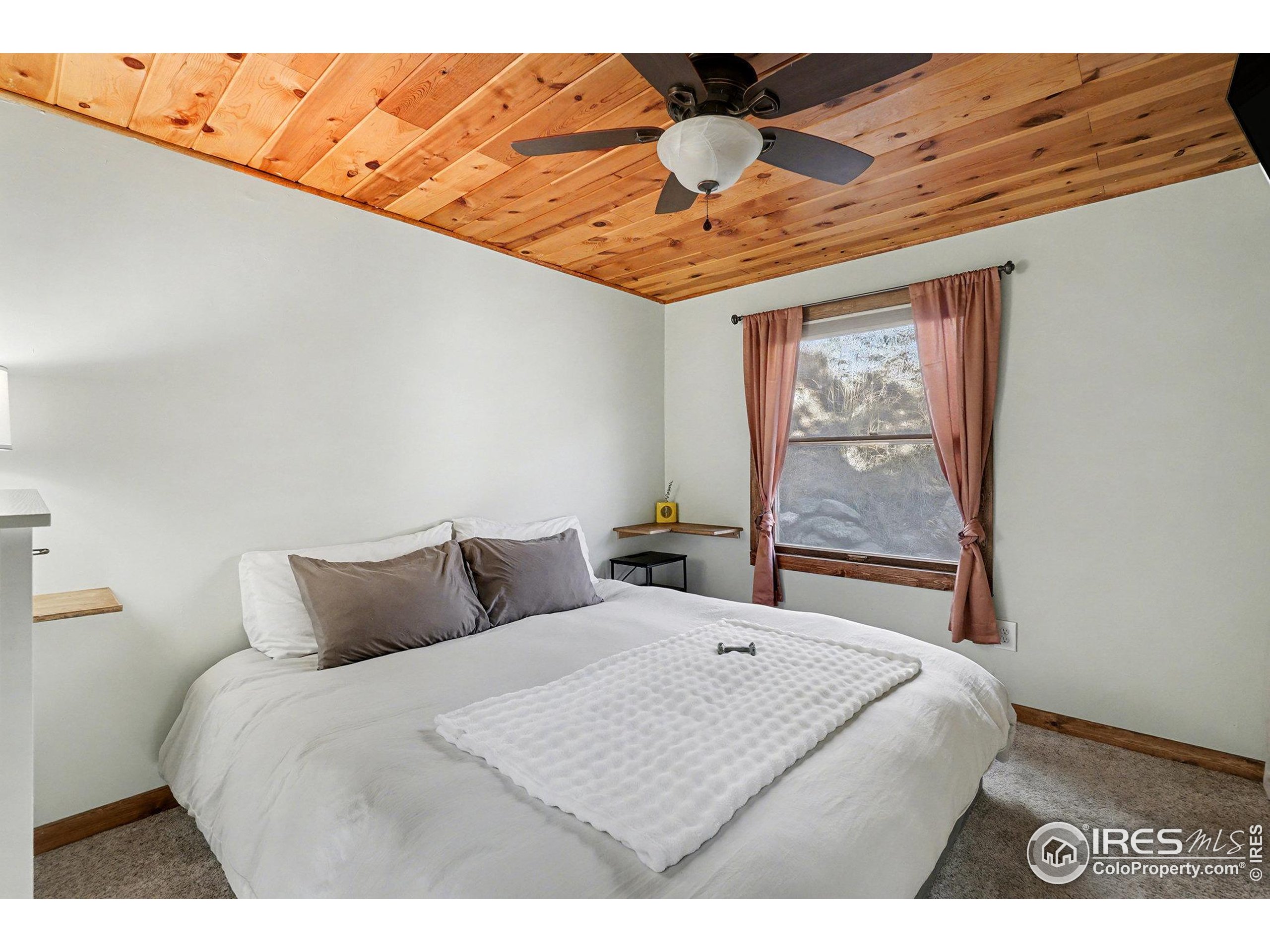 280 Streamside Drive Drake, CO 80515 - Photo 11 of 26 a bedroom with a bed and a window