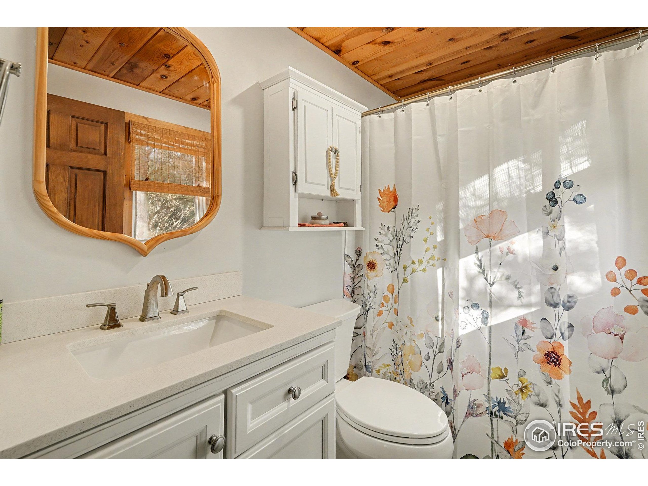 280 Streamside Drive Drake, CO 80515 - Photo 13 of 26 a bathroom with a sink and a mirror