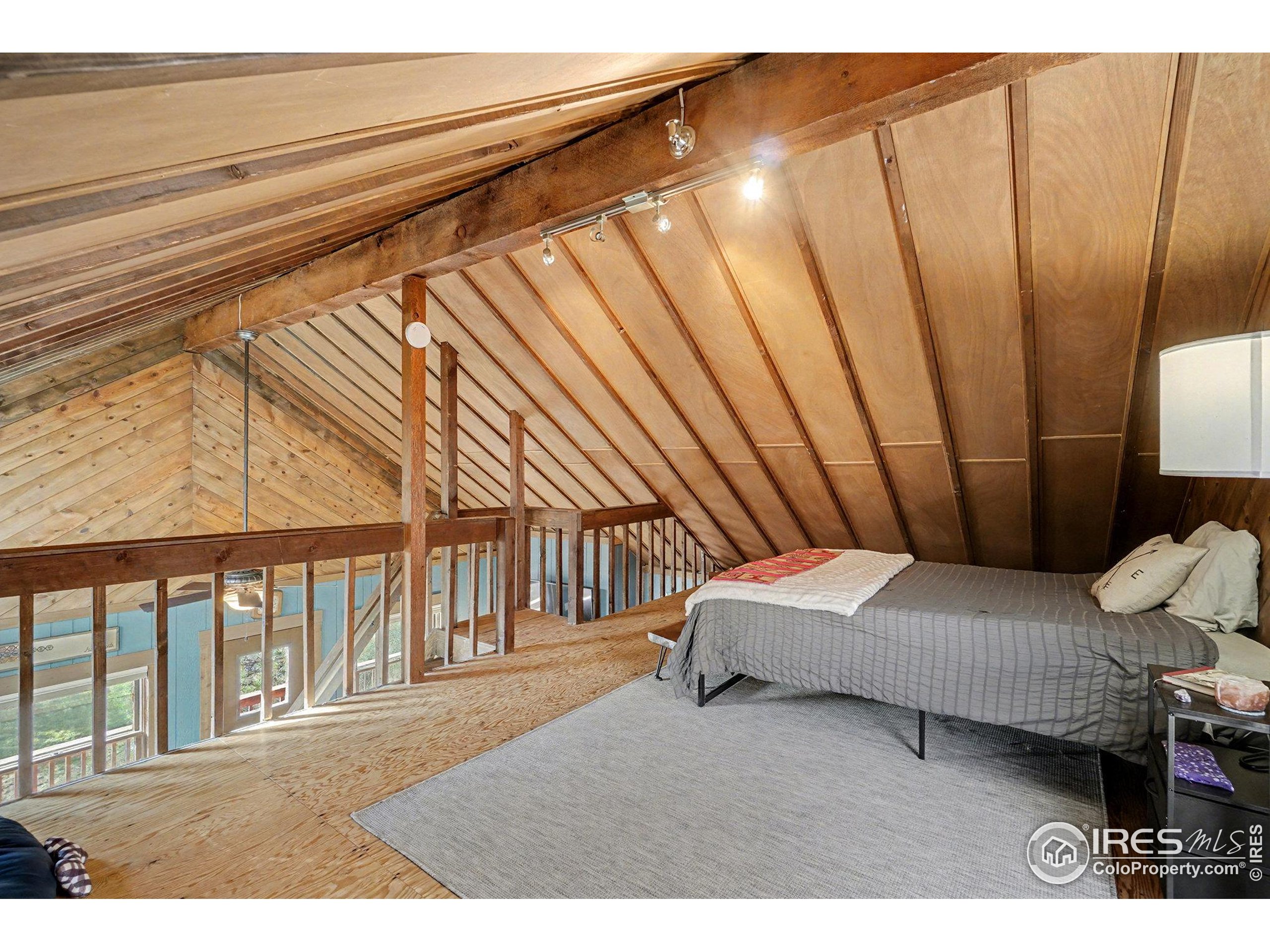 280 Streamside Drive Drake, CO 80515 - Photo 15 of 26 a bedroom with furniture and a wooden floor