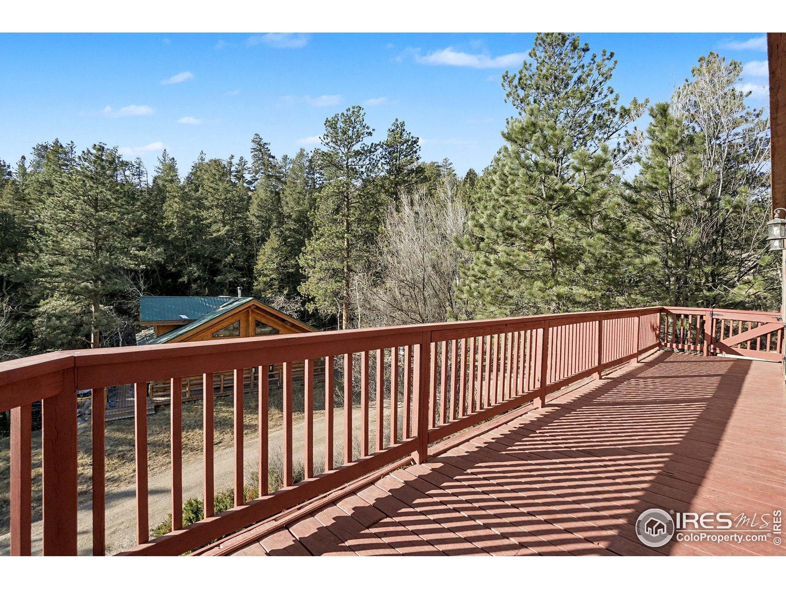 280 Streamside Drive Drake, CO 80515 - Photo 21 of 26 a balcony with wooden floor and fence