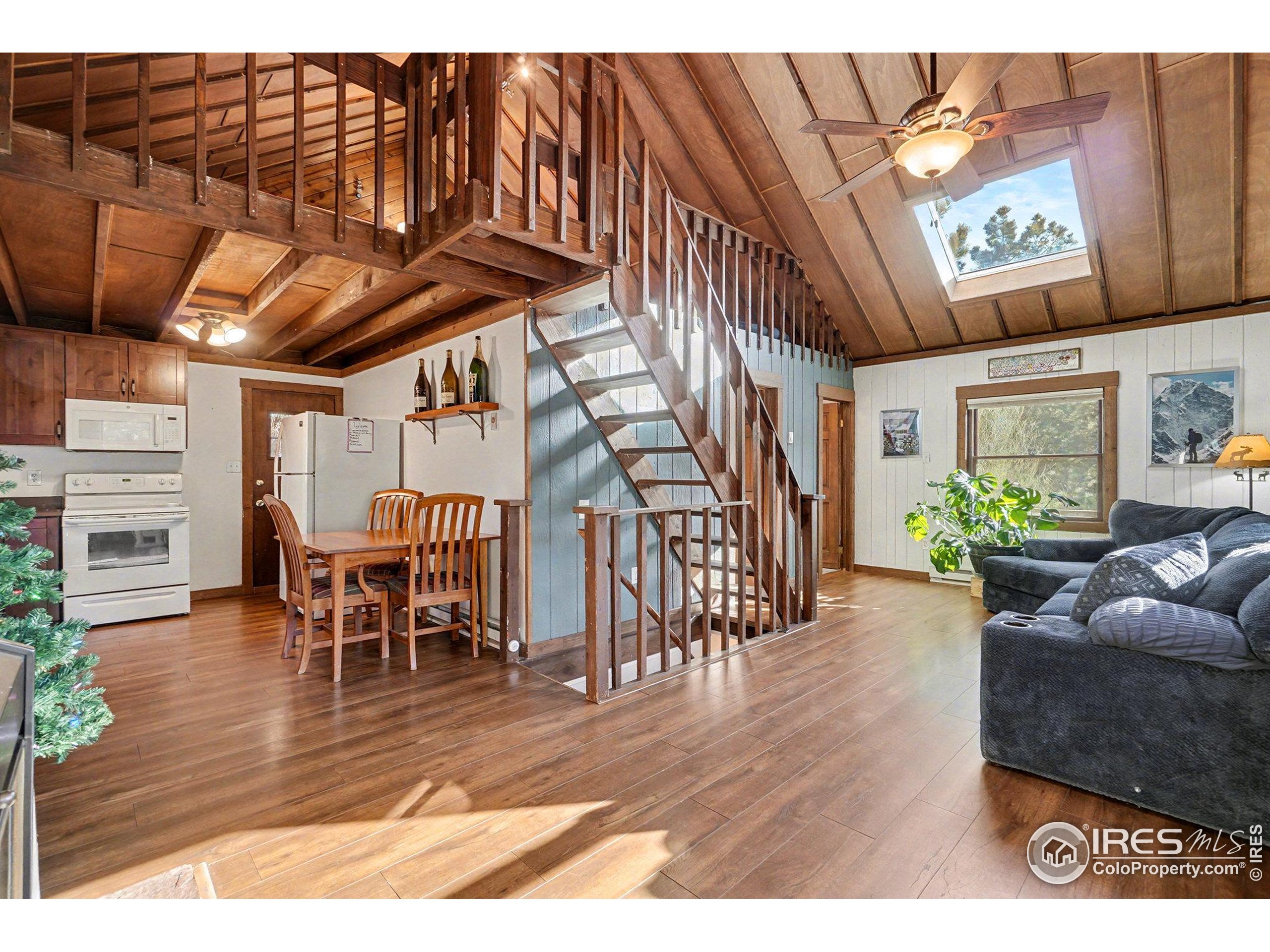 280 Streamside Drive Drake, CO 80515 - Photo 7 of 26 a view of a dining room with furniture window and wooden floor