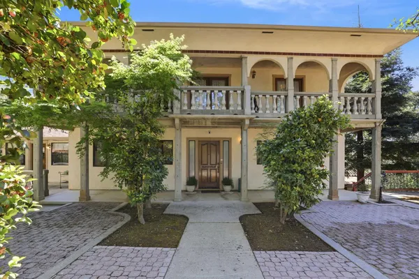 a front view of a house with garden