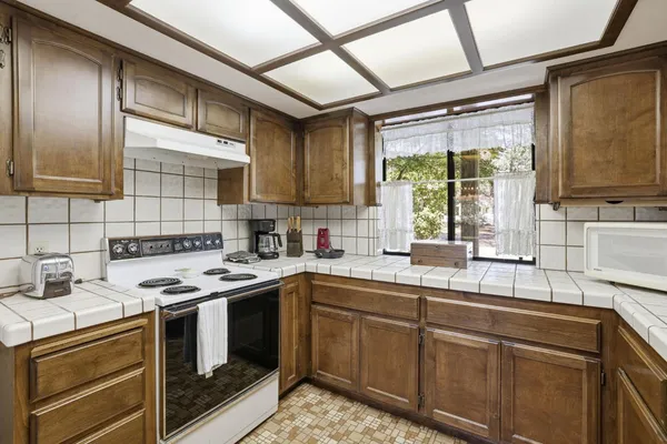 a kitchen with a sink stove and cabinets