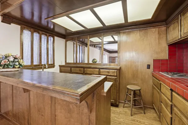 a kitchen with a sink a stove and chairs