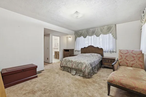 a bedroom with a bed and a couch