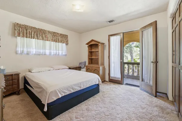 a bedroom with a large bed and a window