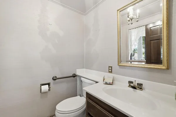 a bathroom with a sink a toilet and mirror