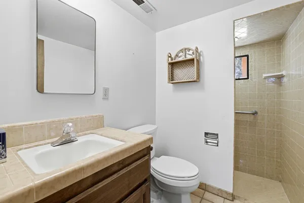 a bathroom with a sink toilet and mirror
