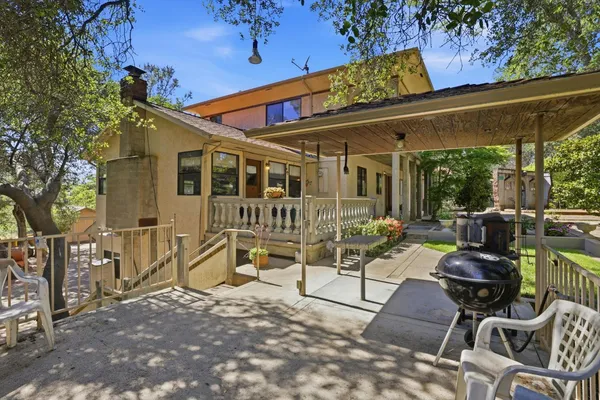 a view of a patio with table and chairs and floor to ceiling window