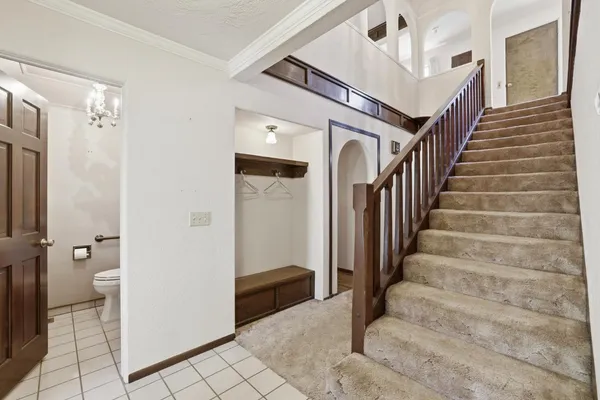 a view of entryway with white walls and open door