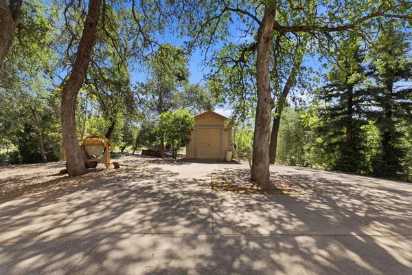 a view of a house with a yard and tree s