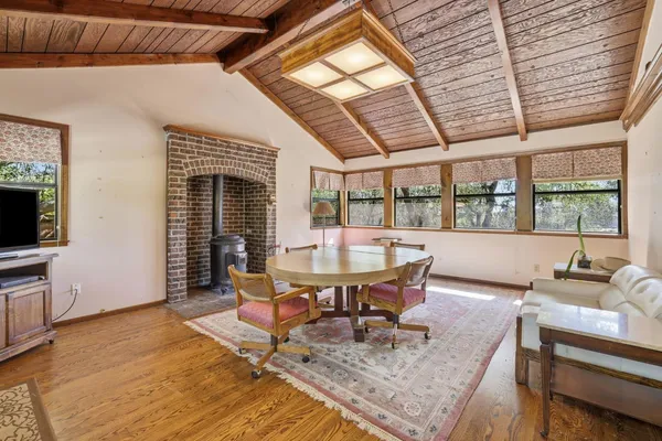 a dining room with furniture window and wooden floor