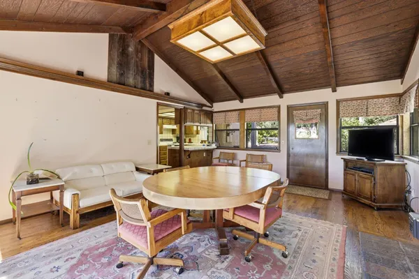 a dining room with furniture and wooden floor
