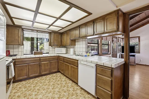 a kitchen with stainless steel appliances granite countertop sink stove and cabinets