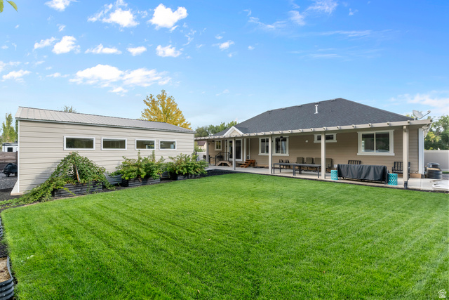 886 River Ridge Lane Spanish Fork, UT 84660 - Photo 17 of 31 Expansive lawn, covered patio, separate outbuilding with multiple windows, and mature landscaping, mulitple berries