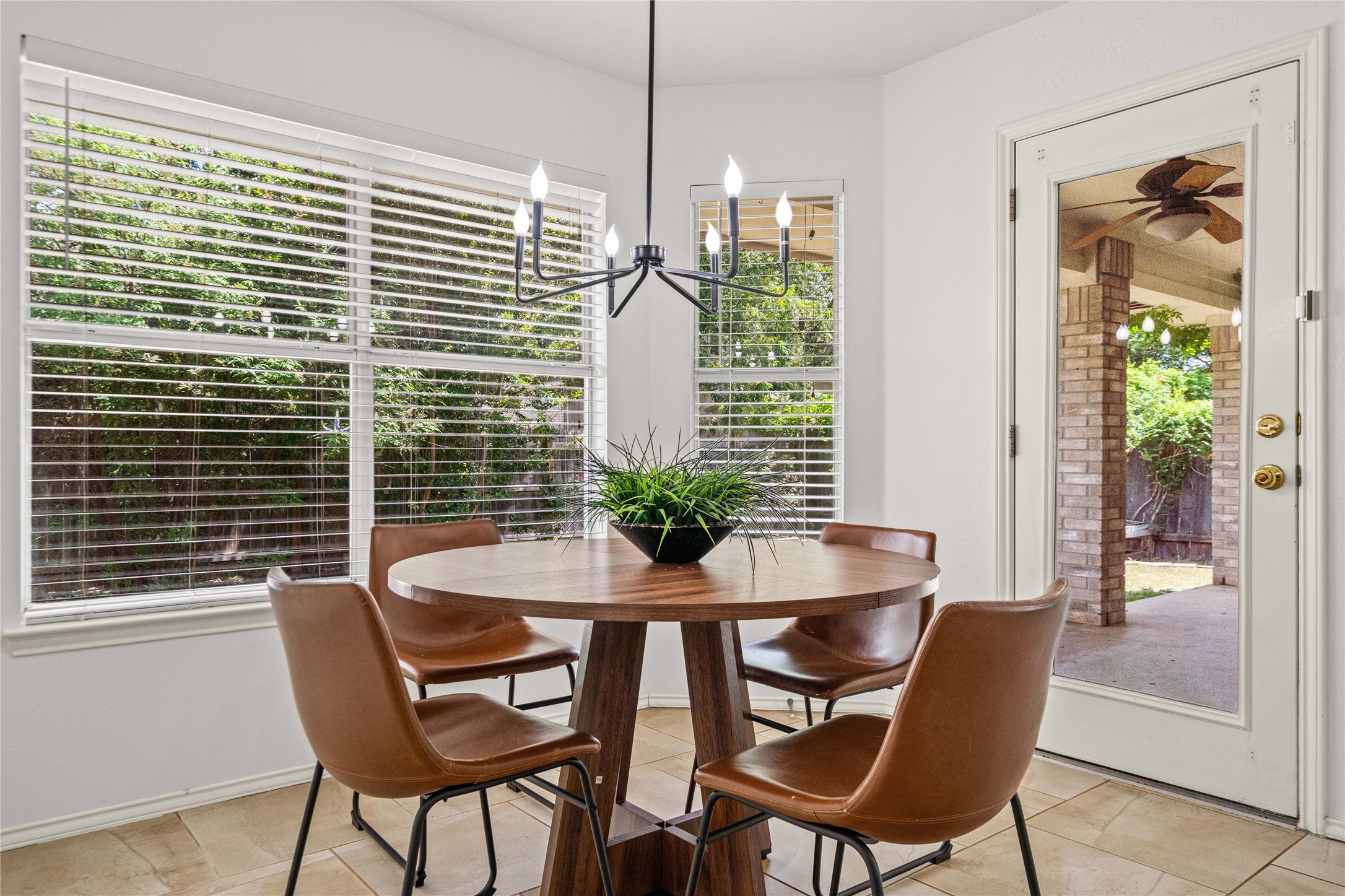 2920 Warwick Way Austin, TX 78748 - Photo 18 of 36 A casual dining area with a new modern chandelier and access to the outdoor patio