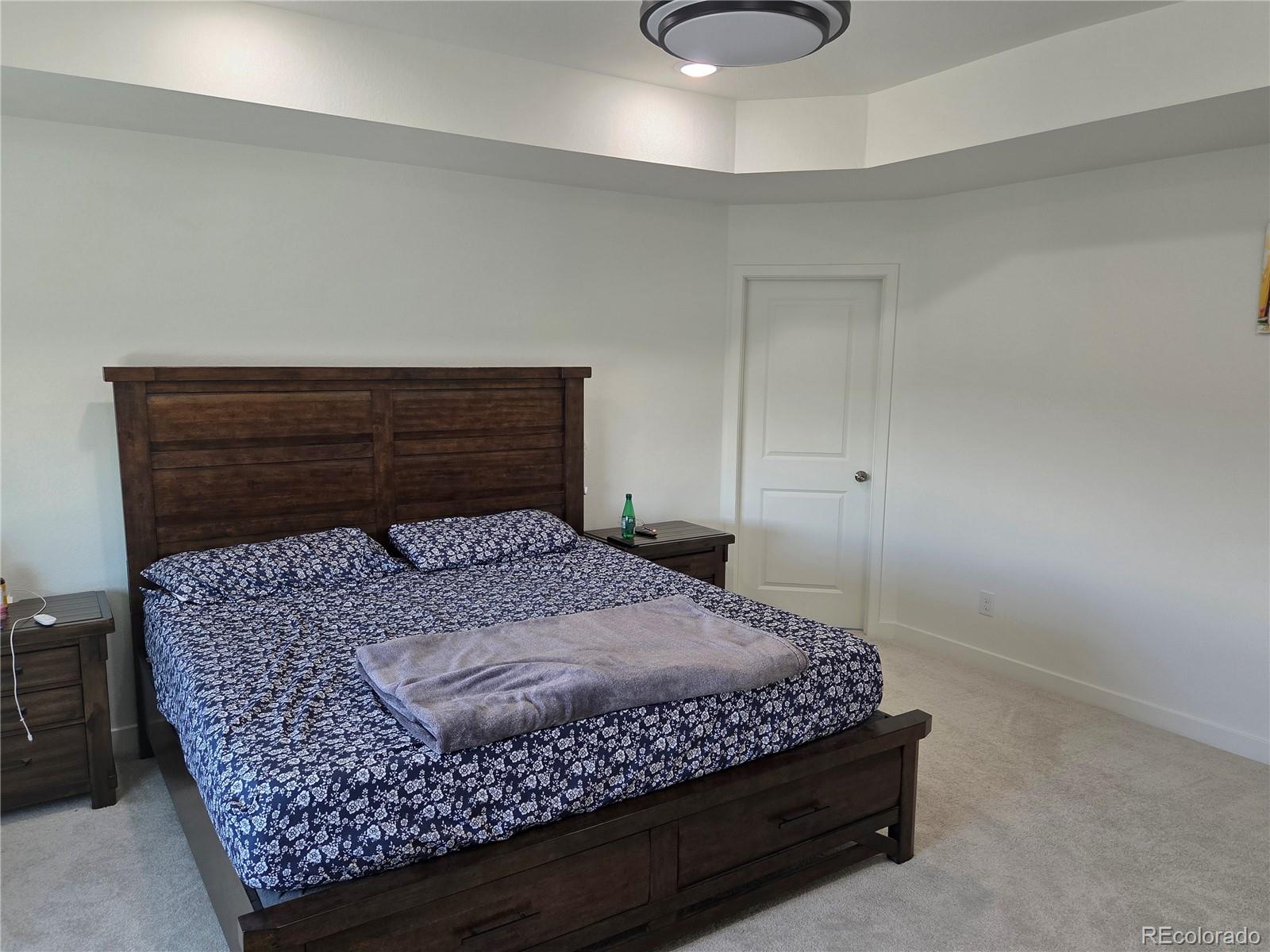 17350 Gandy Dancer Lane Parker, CO 80134 - Photo 13 of 33 a bed sitting in a room next to a lamp