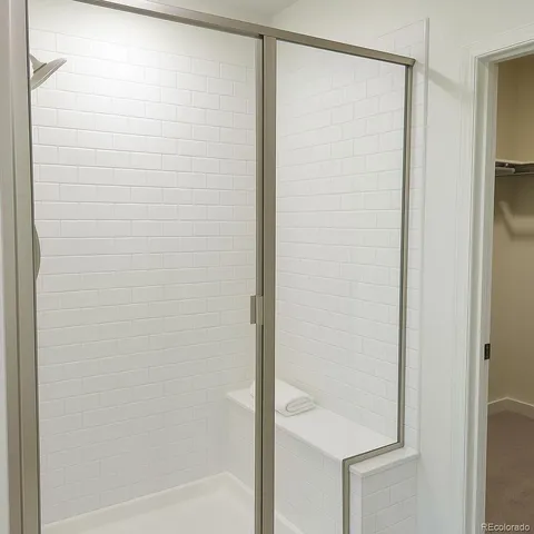 a bathroom with a glass shower door
