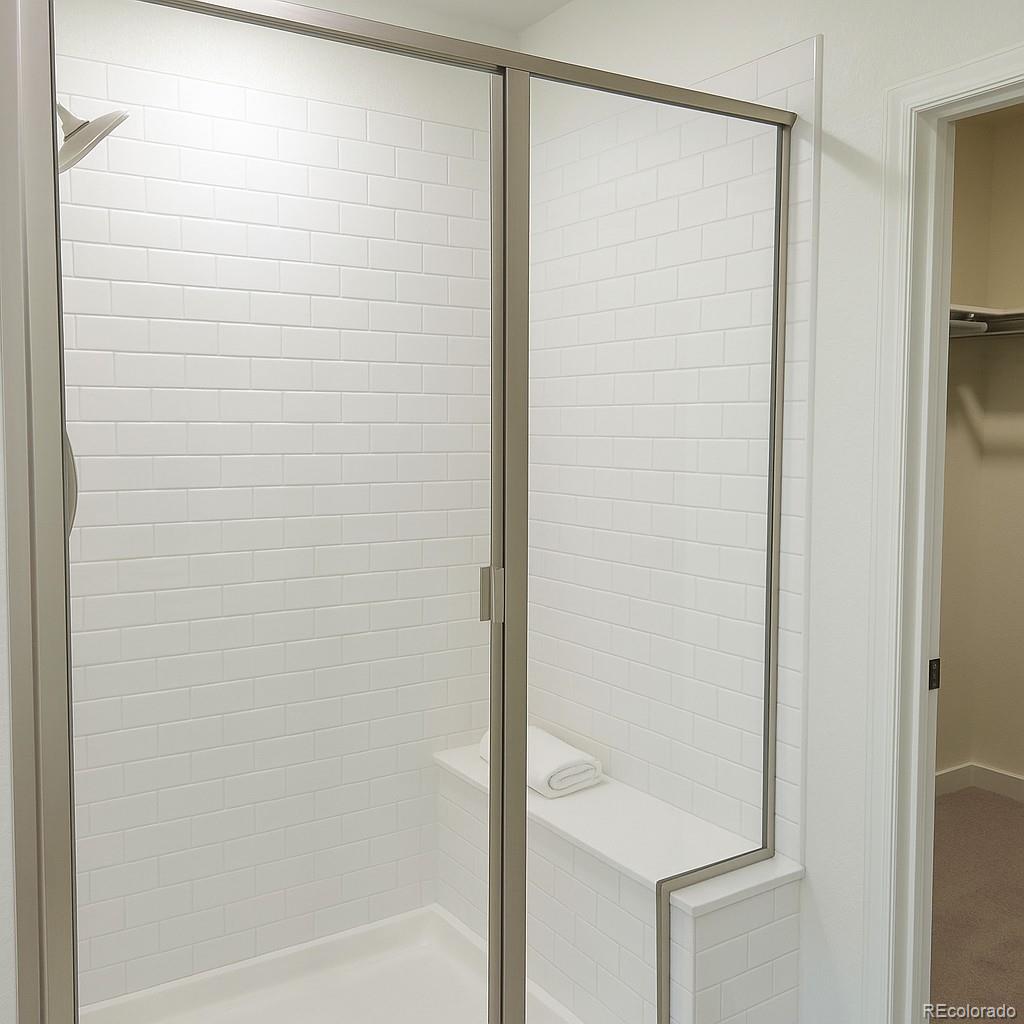 17350 Gandy Dancer Lane Parker, CO 80134 - Photo 15 of 33 a bathroom with a glass shower door