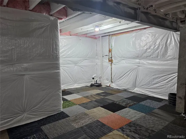 a living room with patio furniture and a rug