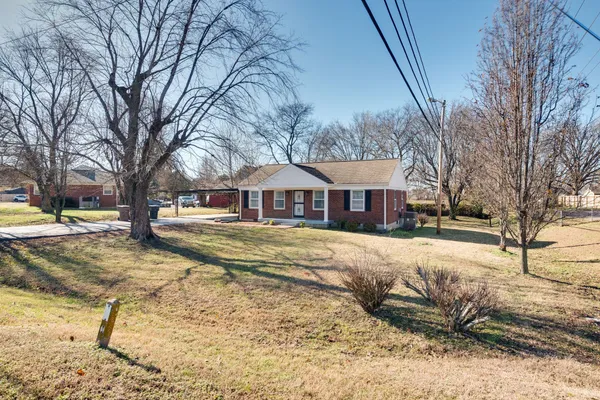 a front view of a house with a yard covered in snow